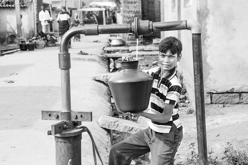 Varied drinking water sources in India - Many a times, leakage from the main source of public water supply itself serves as a drinking water source - at a borewell source in Kolar district, Karnataka